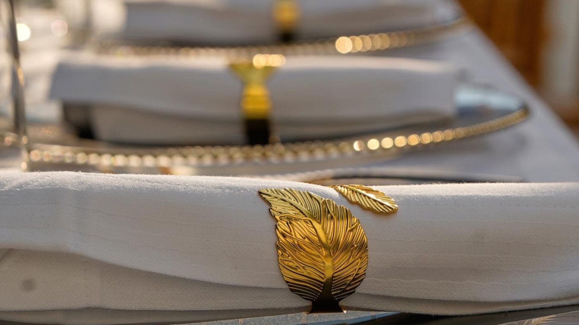 Gold leaf napkin rings on a styled table at a Luxelink Experiences event