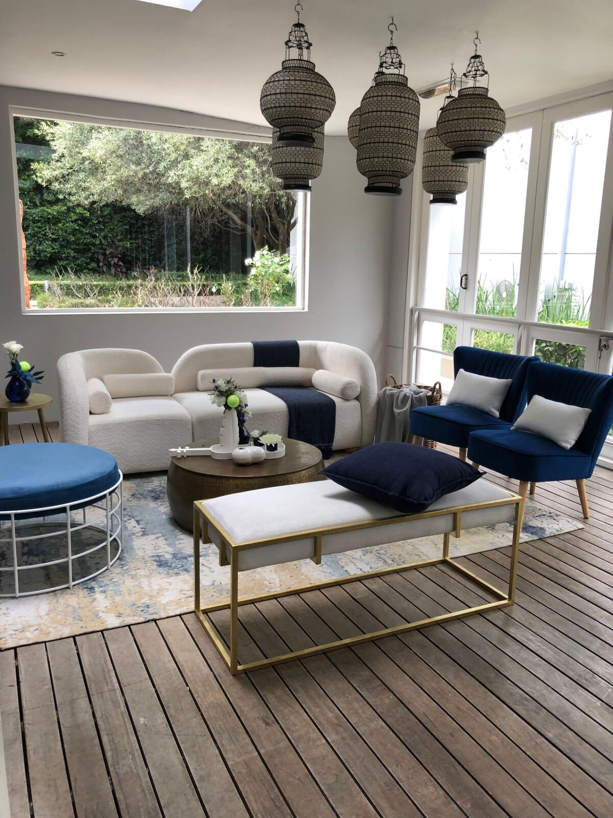 Navy and ivory lounge furniture setup with brass tables